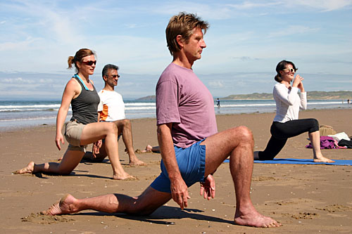yoga teacher training course being taught on a beach